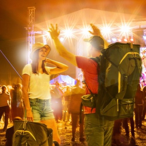 Man and woman at festival with LayBakPak backpacks