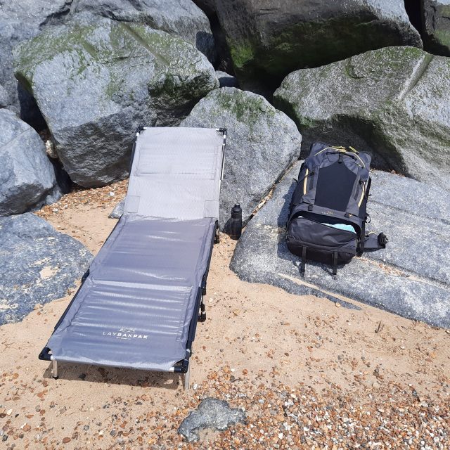 LayBakPak backpack and lounger set up in sheltered area of beach